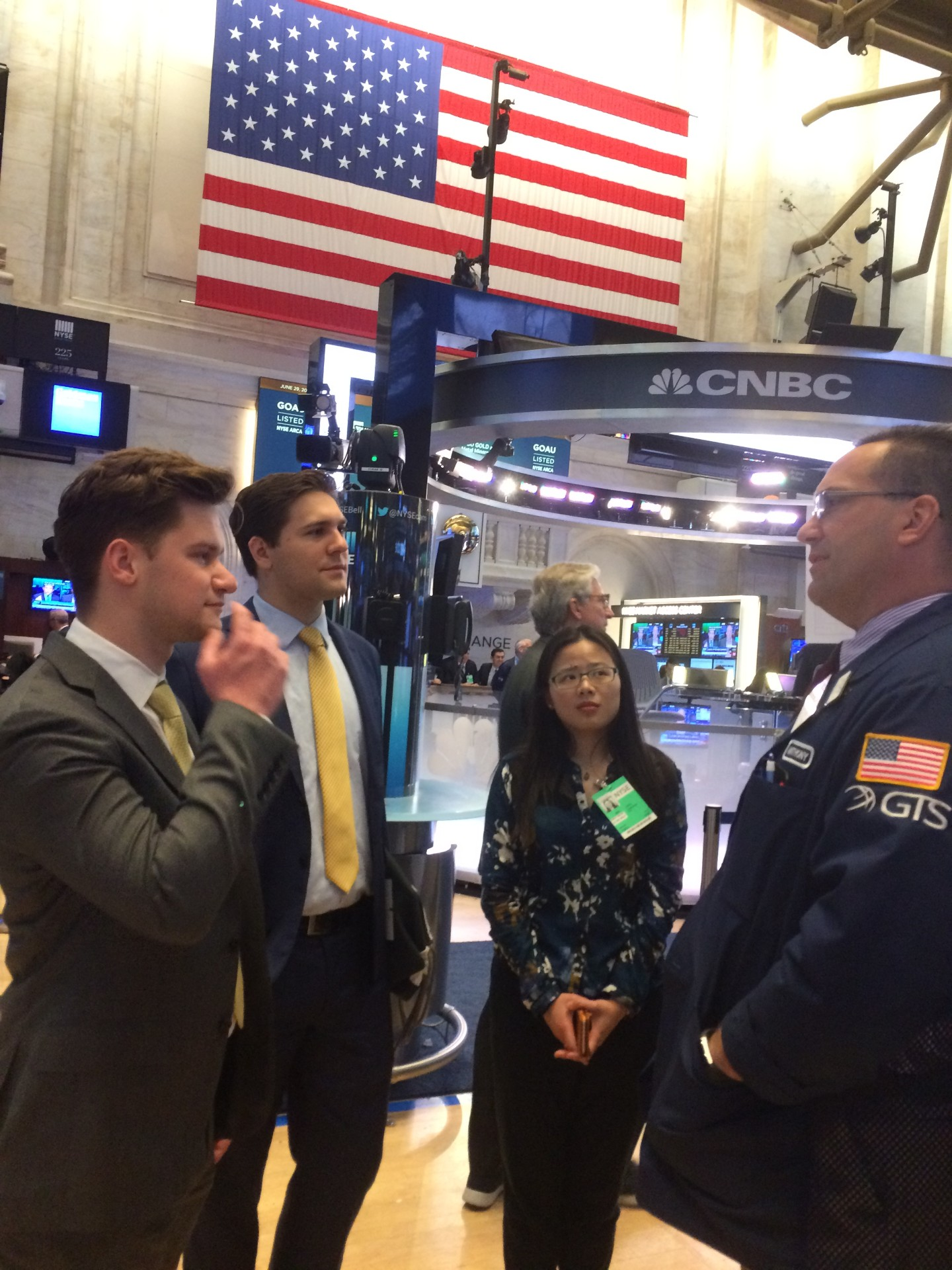 Investors Grow training participants in conversation with a trader on the floor of the New York Stock Exchange